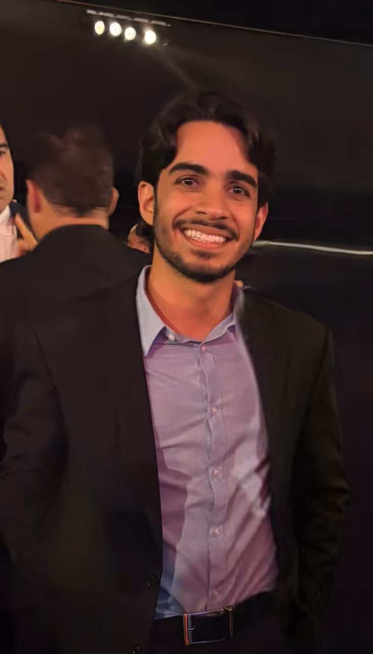João Victor smiling at an evening event
